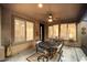 Covered patio with a dining table, ceiling fan, and view to the backyard at 12972 W Kokopelli Dr, Peoria, AZ 85383