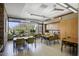 Casual dining room with large windows, multiple tables and chairs, and modern lighting at 12972 W Kokopelli Dr, Peoria, AZ 85383
