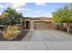 Beautiful home with a well-maintained front yard, desert plants and a large driveway at 12972 W Kokopelli Dr, Peoria, AZ 85383