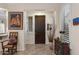 Inviting foyer with tile flooring, plantation shutters, and a decorative wooden door at 12972 W Kokopelli Dr, Peoria, AZ 85383