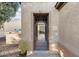 Close up of front door with decorative iron gate and desert landscaping at 12972 W Kokopelli Dr, Peoria, AZ 85383