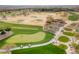Picturesque aerial view of a lush green golf course with players and golf carts at 12972 W Kokopelli Dr, Peoria, AZ 85383