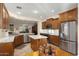 Kitchen boasts stainless appliances, granite counters, and an island; open to other living spaces at 12972 W Kokopelli Dr, Peoria, AZ 85383