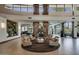 Inviting lobby featuring stone columns, comfortable seating, fireplace, and views to the exterior at 12972 W Kokopelli Dr, Peoria, AZ 85383