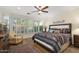 Comfortable main bedroom with wood floors, large windows and southwestern style accents at 12972 W Kokopelli Dr, Peoria, AZ 85383