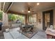 Relaxing covered patio with seating area, ceiling fan, and view of landscaped backyard at 12972 W Kokopelli Dr, Peoria, AZ 85383