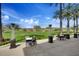 Inviting outdoor patio space with seating and views of the lush green lawn and landscape at 12972 W Kokopelli Dr, Peoria, AZ 85383