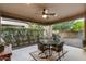 Covered patio with a ceiling fan and a decorative table and chairs, perfect for outdoor dining at 12972 W Kokopelli Dr, Peoria, AZ 85383