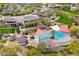 Aerial view of a resort-style pool area with palm trees, lounge chairs, and shade canopies at 12972 W Kokopelli Dr, Peoria, AZ 85383