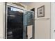 Sleek walk-in shower with black tile, glass door, and a wall-mounted towel bar at 12972 W Kokopelli Dr, Peoria, AZ 85383