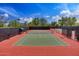 Outdoor tennis courts with lighting, netting, fencing and shade structure on a partly cloudy day at 12972 W Kokopelli Dr, Peoria, AZ 85383