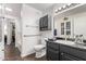 Well-lit bathroom featuring dark cabinets, tile flooring, and accessible grab bars for safety and convenience at 13700 N Fountain Hills Blvd # 155, Fountain Hills, AZ 85268