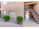Exterior condo elevation with stairs, small bushes, and gravel in the Four Peaks condominium community at 13700 N Fountain Hills Blvd # 155, Fountain Hills, AZ 85268