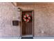 View of front door with a decorative wreath and a visible unit number in the Four Peaks condominium community at 13700 N Fountain Hills Blvd # 155, Fountain Hills, AZ 85268