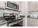 Close-up of the oven and cooktop, showcasing stainless steel appliances, sleek design, and modern touches in Four Peaks condo at 13700 N Fountain Hills Blvd # 155, Fountain Hills, AZ 85268