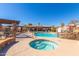 Community pool with hot tub, lounge area, waterfall feature, and a clear blue sky overhead at 13700 N Fountain Hills Blvd # 155, Fountain Hills, AZ 85268