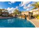 Inviting community pool with a waterfall feature, lounge chairs, and lush landscaping under a bright sky at 13700 N Fountain Hills Blvd # 155, Fountain Hills, AZ 85268