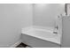 A large bathtub with stylish fixtures is set against the bathroom's clean, white walls at 14000 N 94Th St # 1008, Scottsdale, AZ 85260