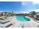 Inviting community pool surrounded by lounge chairs and lush landscaping on a sunny day at 14000 N 94Th St # 1008, Scottsdale, AZ 85260