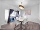 Dining area with an elegant chandelier, modern furniture, and sliding glass doors at 14000 N 94Th St # 1008, Scottsdale, AZ 85260