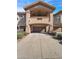 Front exterior of home showing driveway leading to a two-car garage, with desert landscaping at 14000 N 94Th St # 1008, Scottsdale, AZ 85260