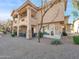 Exterior view of a multi-story home featuring a gravel yard and covered patio at 14000 N 94Th St # 1008, Scottsdale, AZ 85260