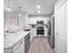 Well-lit kitchen with stainless appliances, granite counters, and a stylish faucet at 14000 N 94Th St # 1008, Scottsdale, AZ 85260