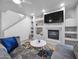 Modern living room features a fireplace, mounted television, and built-in shelving at 14000 N 94Th St # 1008, Scottsdale, AZ 85260