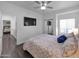 Cozy main bedroom featuring a ceiling fan, mounted TV, and sliding door closet at 14000 N 94Th St # 1008, Scottsdale, AZ 85260