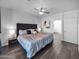 Comfortable bedroom with an ensuite bath featuring hardwood floors and ceiling fan at 14000 N 94Th St # 1008, Scottsdale, AZ 85260