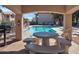 Community pool area with a grilling station and picnic table at 14000 N 94Th St # 1008, Scottsdale, AZ 85260