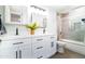 Bright bathroom with dual sinks, modern fixtures, white cabinets and a shower with glass doors at 1630 E Minton Dr, Tempe, AZ 85282