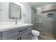 Modern bathroom featuring a gray vanity with white countertop and a glass enclosed shower with tile accents at 1630 E Minton Dr, Tempe, AZ 85282