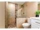 Bright bathroom featuring stone accents in the glass enclosed shower with a modern vanity at 1630 E Minton Dr, Tempe, AZ 85282