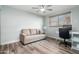 Bright room with hardwood floors, neutral paint, modern ceiling fan, and an area for a desk setup at 1630 E Minton Dr, Tempe, AZ 85282