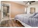 Bedroom featuring wood-look floors and a bathroom that is visible with a glass enclosed shower at 1630 E Minton Dr, Tempe, AZ 85282