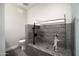 Dog bath featuring gray tile, shower head, and drying rack plus a cute dog enjoying the bath at 1630 E Minton Dr, Tempe, AZ 85282