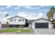 Beautiful two story home featuring a large paved driveway, manicured lawn, and a two car garage at 1630 E Minton Dr, Tempe, AZ 85282
