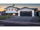 Beautifully renovated two-story home with a black garage door and dark trim accents at 1630 E Minton Dr, Tempe, AZ 85282