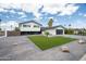A stunning two-story home with mature palm trees, an oversized driveway and a manicured lawn at 1630 E Minton Dr, Tempe, AZ 85282