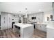 Bright kitchen with a center island, gray cabinets, stainless steel appliances, and modern lighting at 1630 E Minton Dr, Tempe, AZ 85282