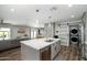 Open concept kitchen with a marble island, updated appliances, and a living area view at 1630 E Minton Dr, Tempe, AZ 85282