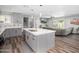 Open kitchen with a large island, stainless steel appliances, and a seamless connection to the living room at 1630 E Minton Dr, Tempe, AZ 85282
