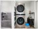 Modern laundry room featuring a stacked washer and dryer, plus a dog washing station with gray tile at 1630 E Minton Dr, Tempe, AZ 85282