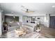 Inviting living space with a gray sofa, modern ceiling fan, and a view into the updated kitchen at 1630 E Minton Dr, Tempe, AZ 85282