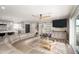 Comfortable living room with a modern ceiling fan and an adjacent open kitchen area at 1630 E Minton Dr, Tempe, AZ 85282