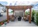 Outdoor seating area under a shaded pergola with mature landscaping for relaxing and entertaining at 1630 E Minton Dr, Tempe, AZ 85282
