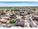 An aerial view of a residential area with homes, landscaping, pools, and solar panels on some roofs at 17258 W Meghan Dr, Goodyear, AZ 85338