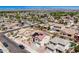 Aerial view of a neighborhood with a home featuring a pool, landscaping, and solar panels on its roof at 17258 W Meghan Dr, Goodyear, AZ 85338