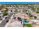 An aerial shot of a home with backyard pool, patio, solar panels, landscaping, and surrounding neighborhood at 17258 W Meghan Dr, Goodyear, AZ 85338